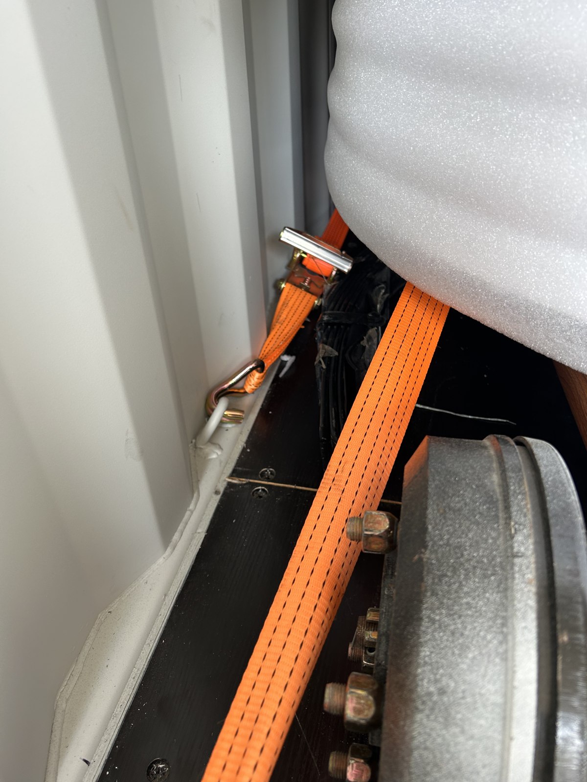 Restraint straps fitted around the trailer inside the container