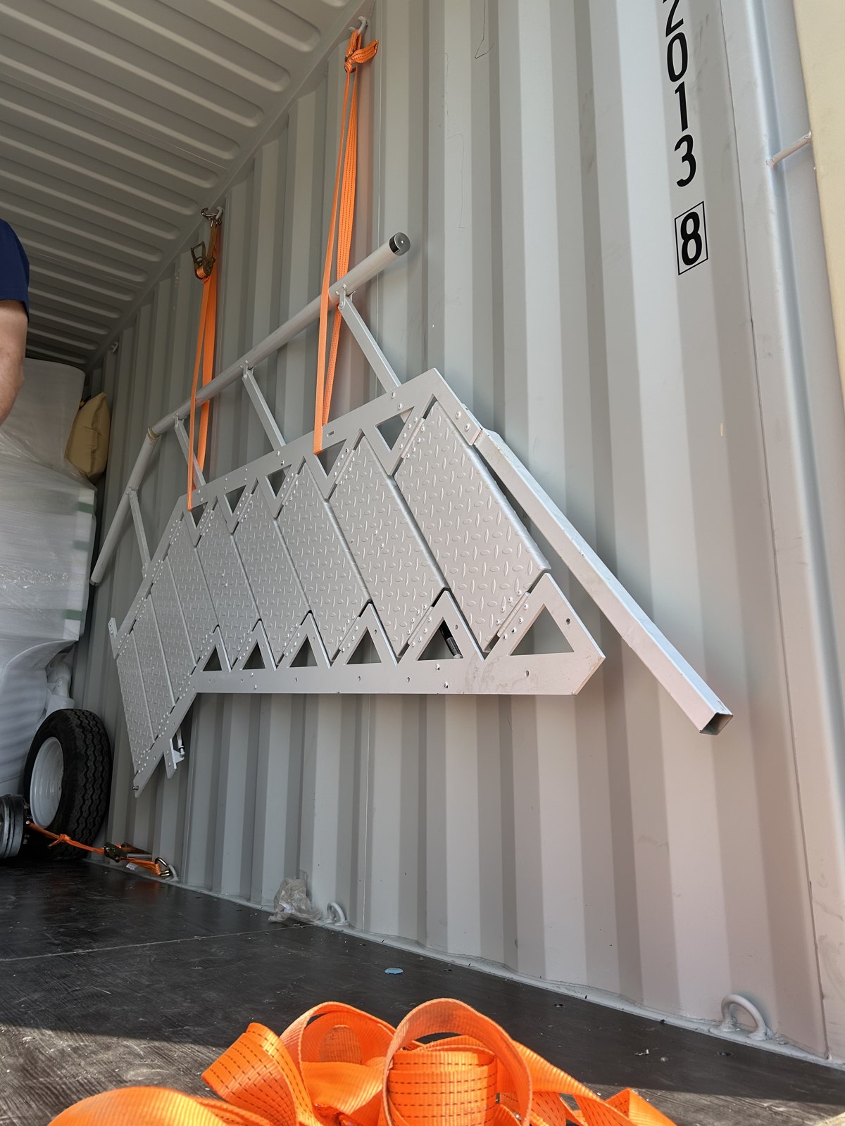 Removed ladder arranged along the container wall