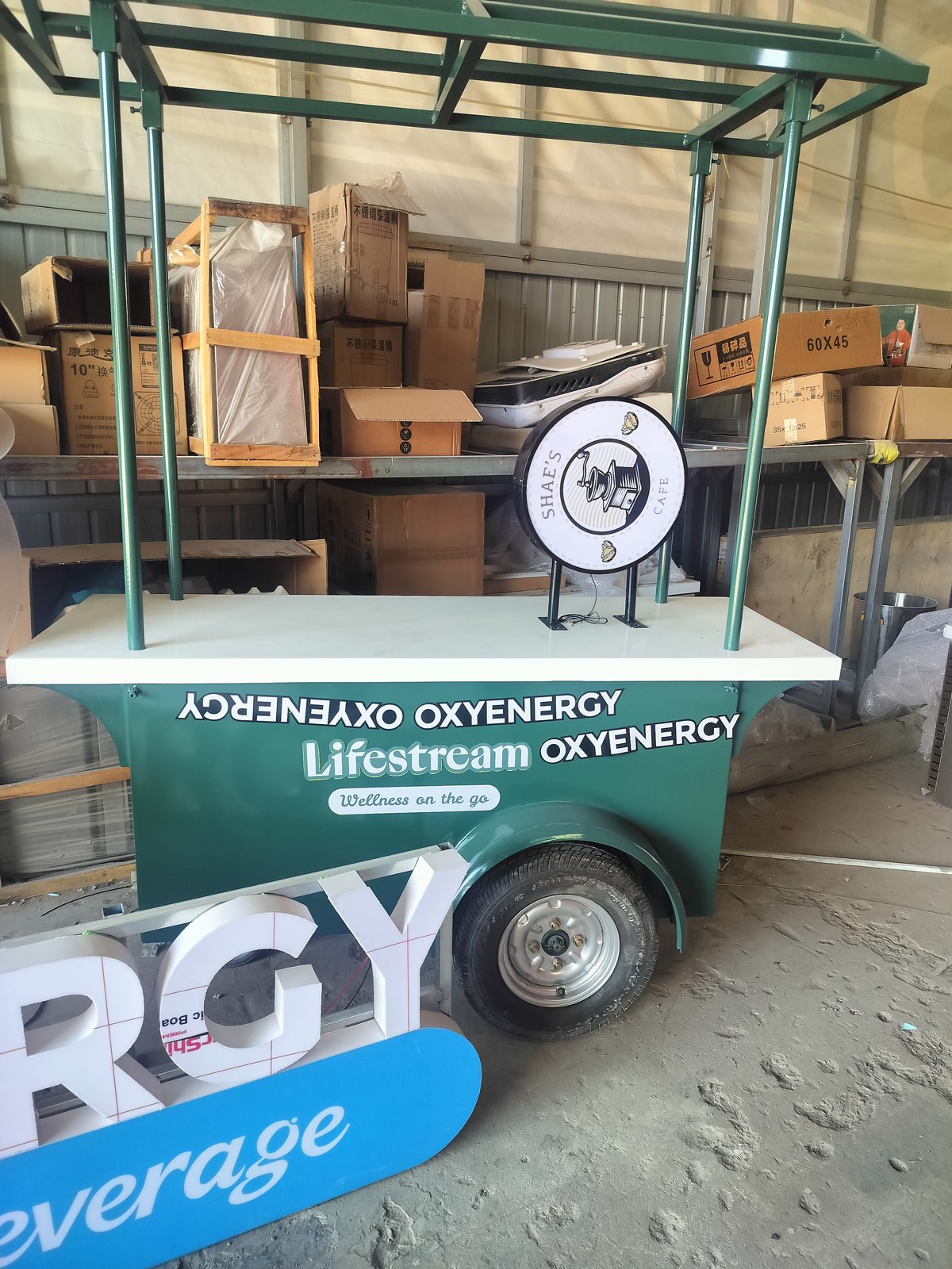 The two sets of branded signs and matching sampling carts in the workshop