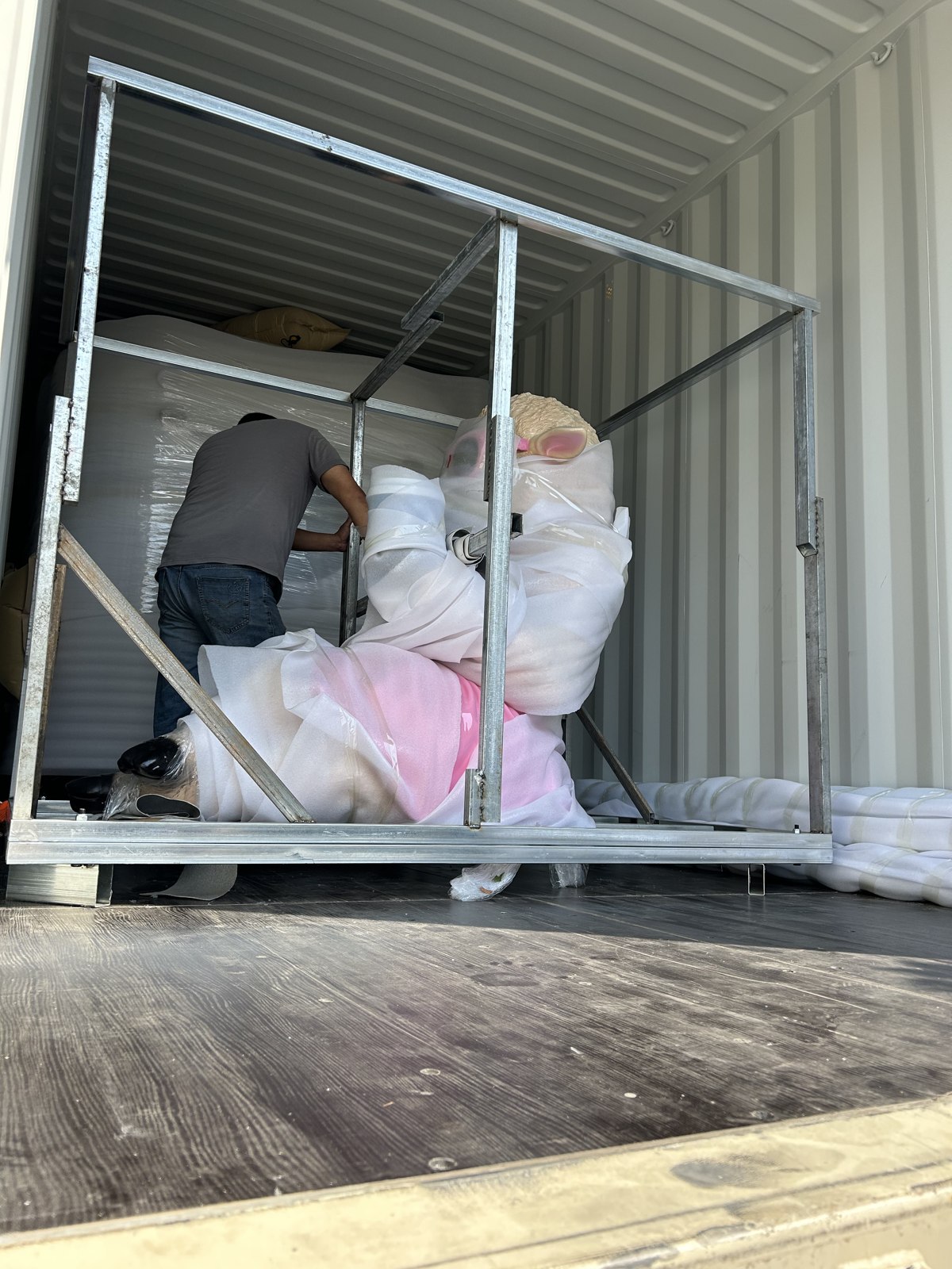 Sculpture and frame being placed inside the container