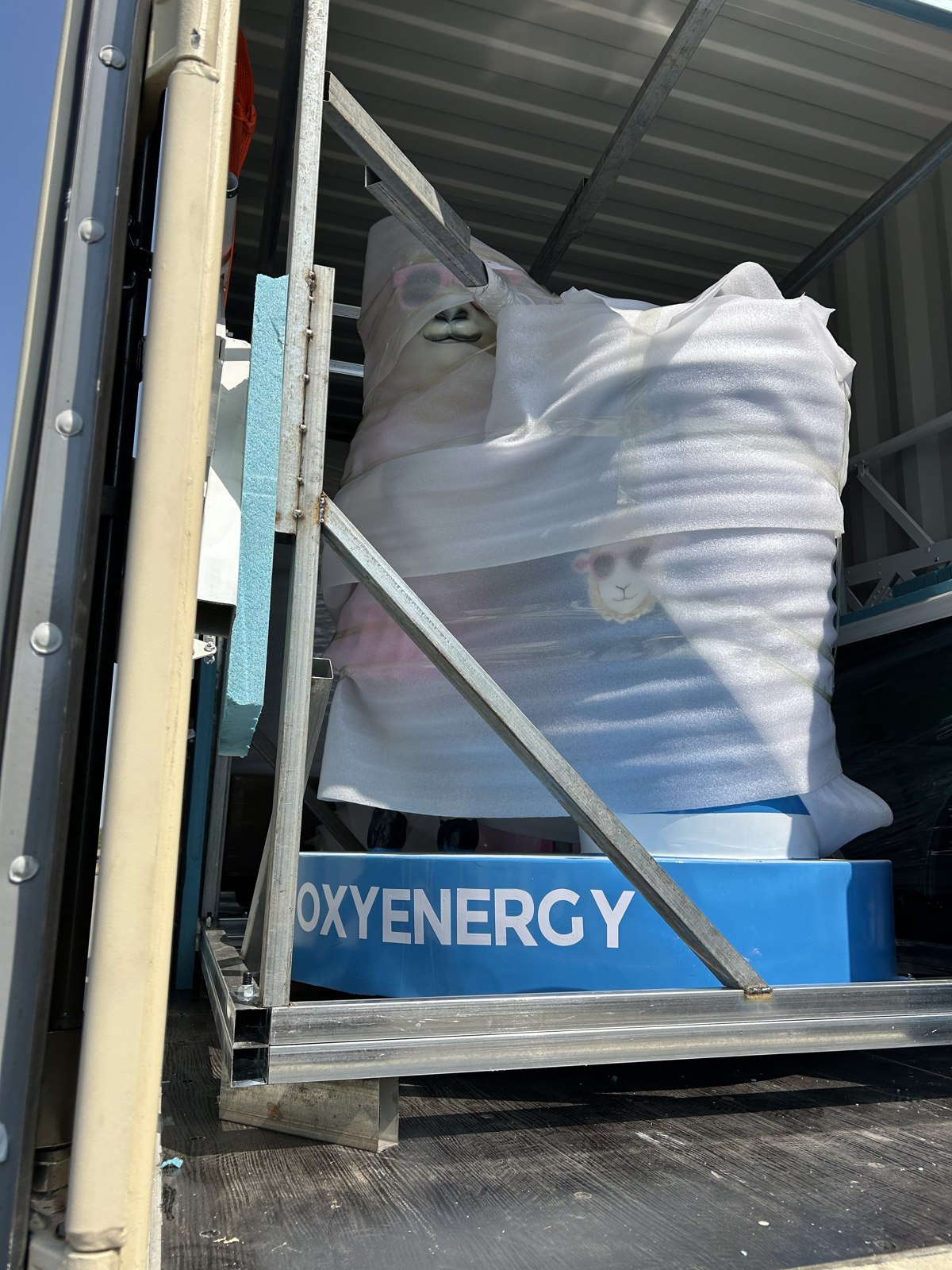 The sculpture and its protective frame in their container position