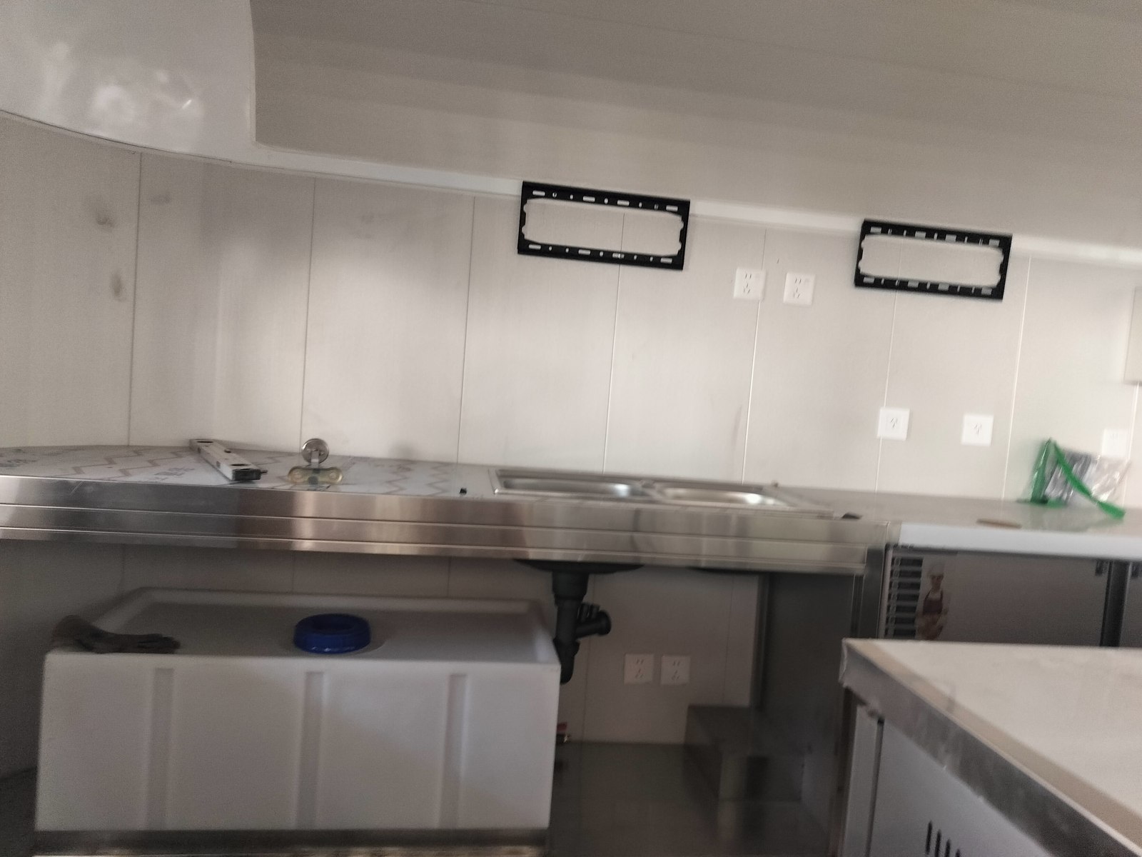 Sinks and worktop taking shape, with the space underneath still being arranged