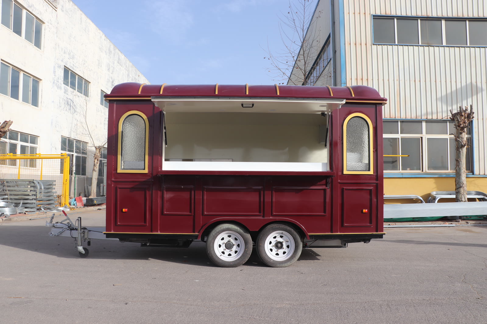 Completed burgundy food trailer outside the factory